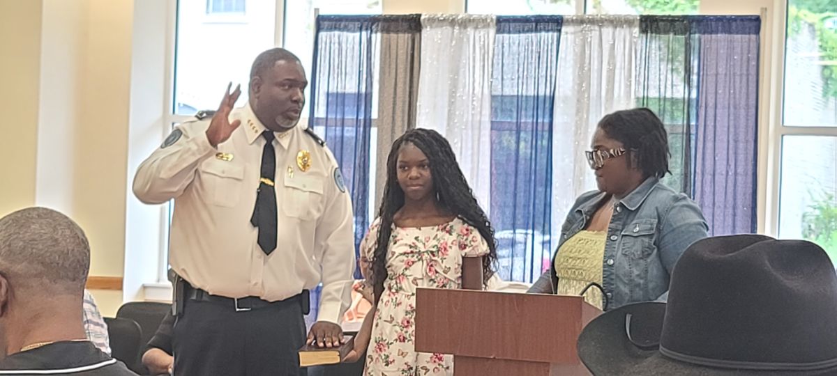 Chief Arbuthnot with his daughter being sworn in as Chief of police